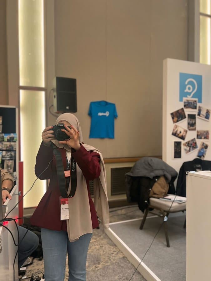 Rahaf photographing with a camera on assignment